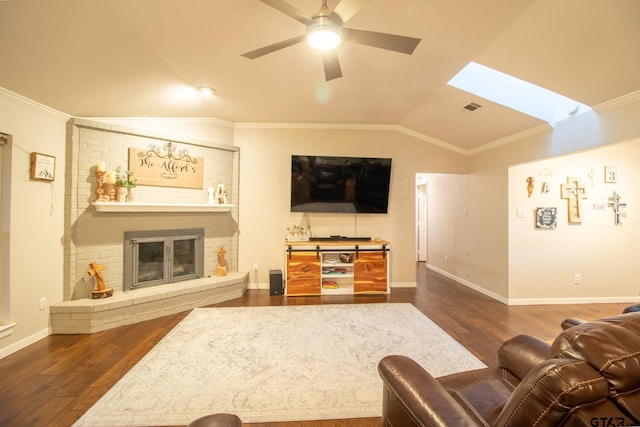 living room with dark wood-type flooring, vaulted ceiling with skylight, and crown molding