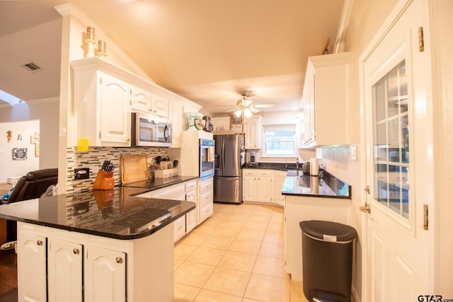 kitchen with a peninsula, white cabinetry, and stainless steel appliances