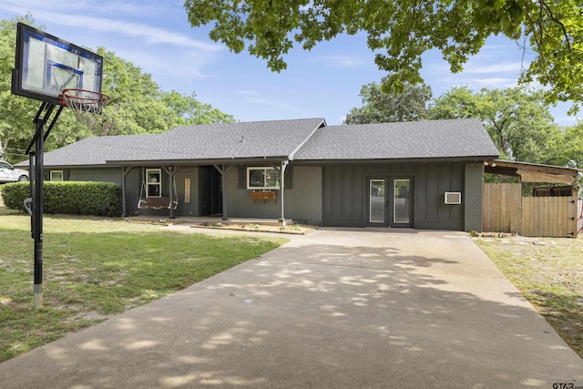 14553 Stone Creek Dr, Tyler, TX 75709 - ranch-style house featuring french doors, fence, a shingled roof, board and batten siding, and a front lawn