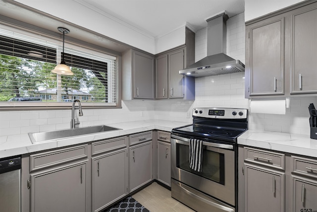 14553 Stone Creek Dr, Tyler, TX 75709 - kitchen featuring a sink, stainless steel appliances, gray cabinets, wall chimney range hood, and tasteful backsplash