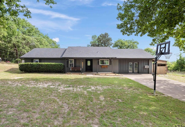 14553 Stone Creek Dr, Tyler, TX 75709 - ranch-style house with concrete driveway, board and batten siding, french doors, and a front lawn