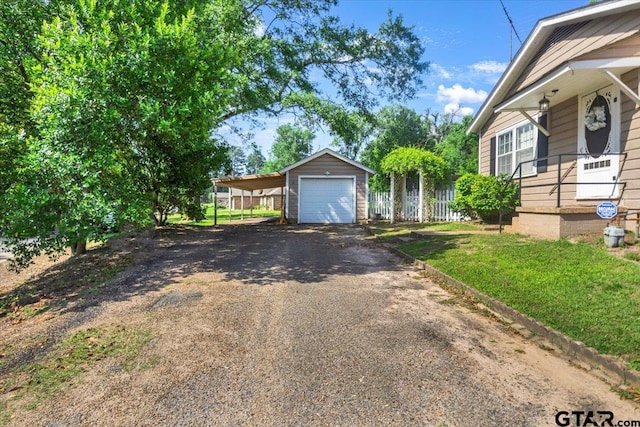 13926 State Highway 64e, Tyler, TX 75707 - view of front of home with driveway, a garage, and an outbuilding