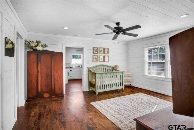 13926 State Highway 64e, Tyler, TX 75707 - bedroom featuring wood finished floors, wood walls, and a ceiling fan