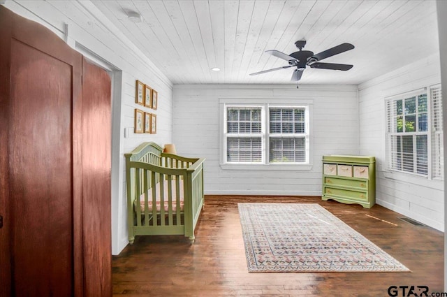 13926 State Highway 64e, Tyler, TX 75707 - bedroom with wood ceiling, wood finished floors, a ceiling fan, and wooden walls