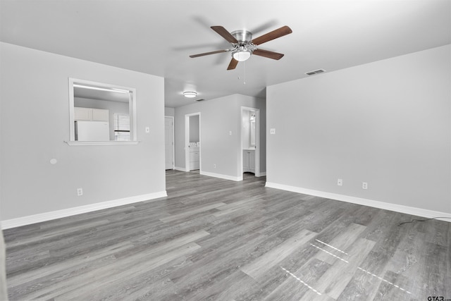 104 E Cedar St, Tyler, TX 75702 - unfurnished living room featuring ceiling fan, wood finished floors, and baseboards