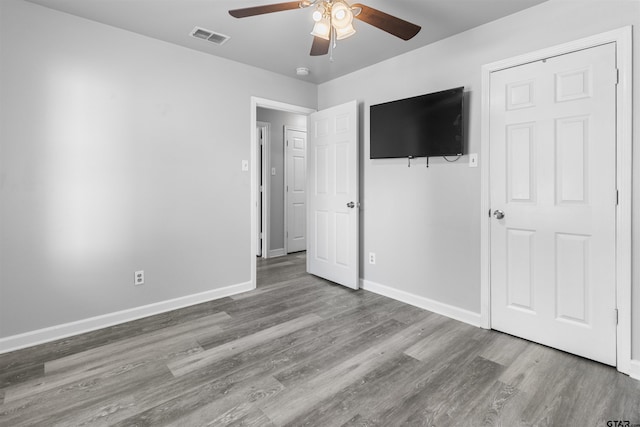 104 E Cedar St, Tyler, TX 75702 - unfurnished bedroom featuring wood finished floors, baseboards, and a ceiling fan