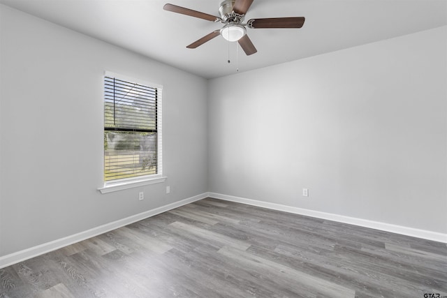 104 E Cedar St, Tyler, TX 75702 - unfurnished room with wood finished floors, ceiling fan, and baseboards