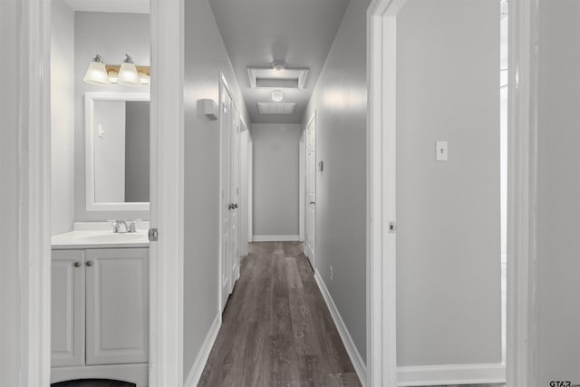 104 E Cedar St, Tyler, TX 75702 - hallway featuring a sink, dark wood-type flooring, and baseboards