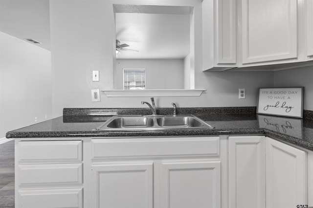 104 E Cedar St, Tyler, TX 75702 - kitchen with a sink, white cabinetry, a ceiling fan, and dark stone countertops