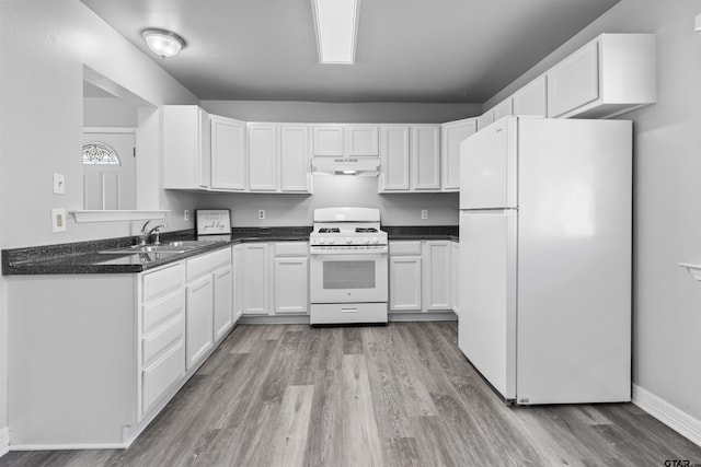 104 E Cedar St, Tyler, TX 75702 - kitchen with white appliances, under cabinet range hood, a sink, light wood-style flooring, and white cabinets