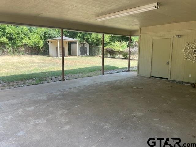 view of patio / terrace with a shed and a carport