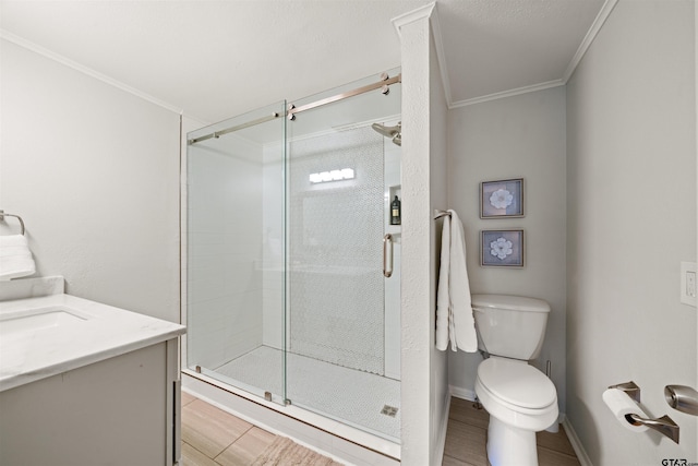 bathroom with toilet, wood-type flooring, crown molding, and vanity