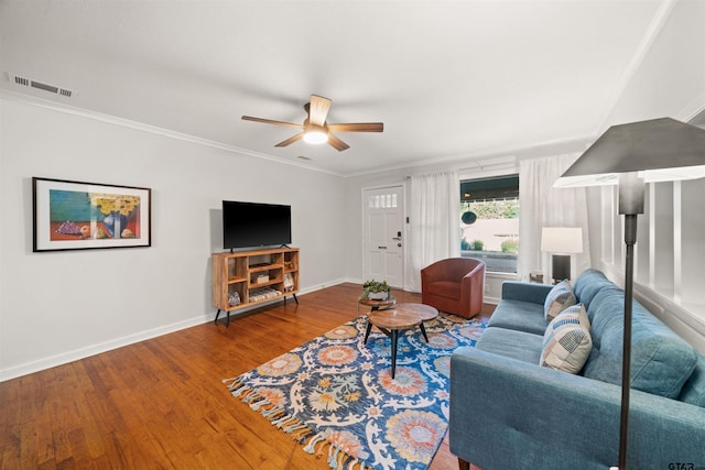 living room featuring ceiling fan, wood-type flooring, and ornamental molding