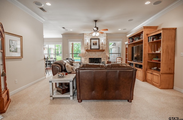 living room with a stone fireplace, light colored carpet, ornamental molding, and ceiling fan