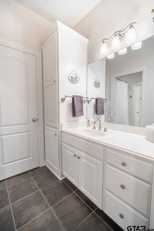 bathroom featuring tile patterned flooring and vanity