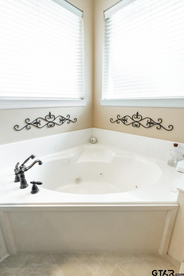 bathroom featuring a tub to relax in and tile patterned floors