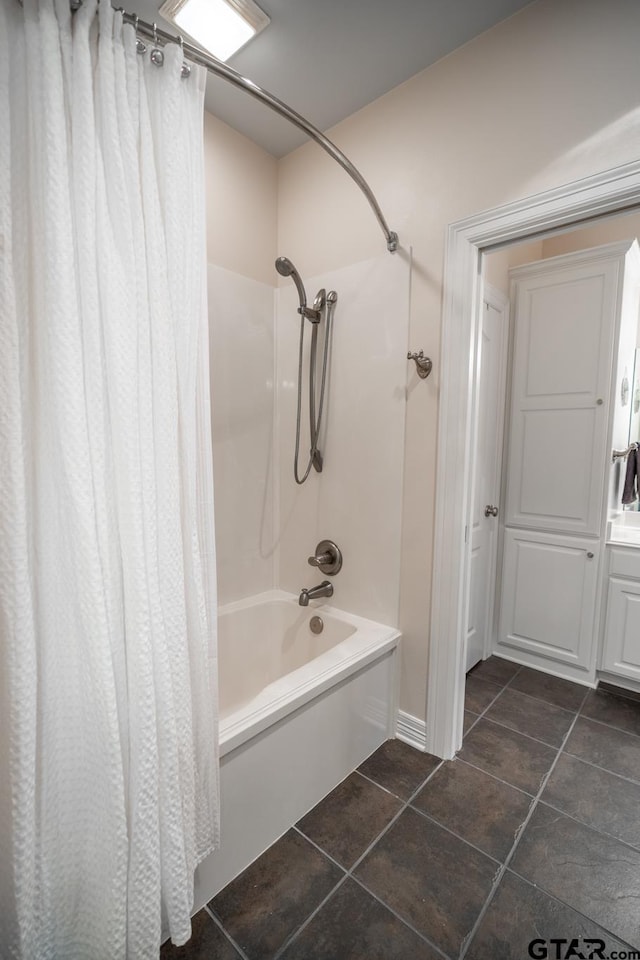 bathroom with shower / bath combo with shower curtain and tile patterned floors