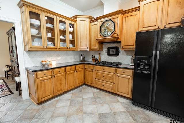 kitchen featuring ornamental molding, black fridge with ice dispenser, stainless steel gas stovetop, and tasteful backsplash