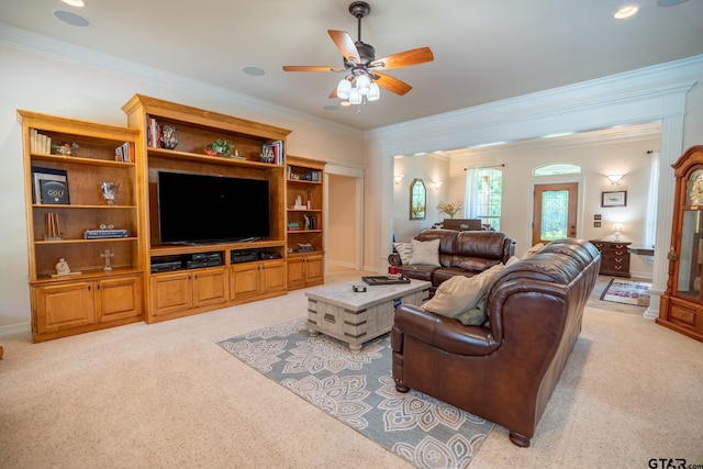 carpeted living room featuring ceiling fan and crown molding