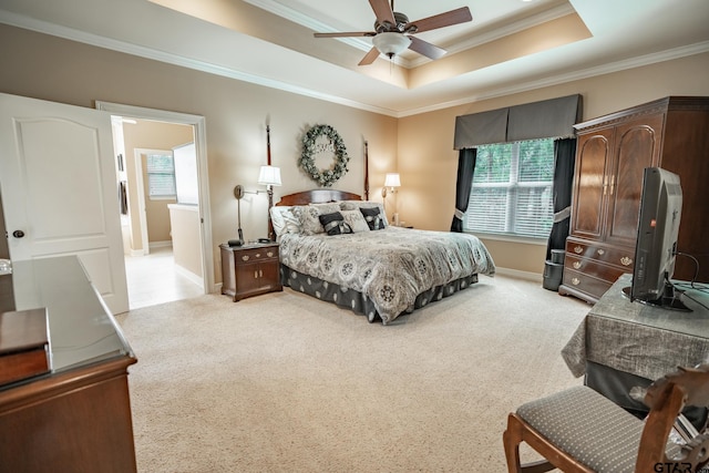 bedroom featuring ornamental molding, light carpet, ceiling fan, and a raised ceiling