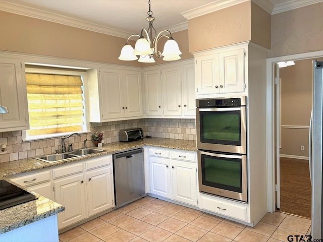 kitchen featuring sink, white cabinetry, decorative light fixtures, and stainless steel appliances