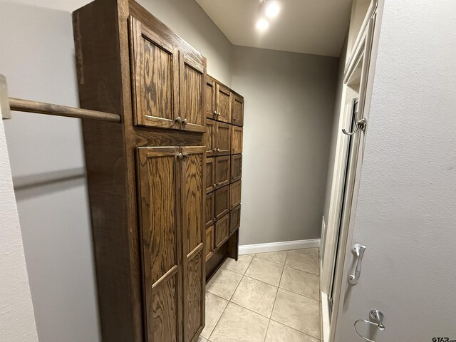 interior space featuring tile patterned floors and baseboards