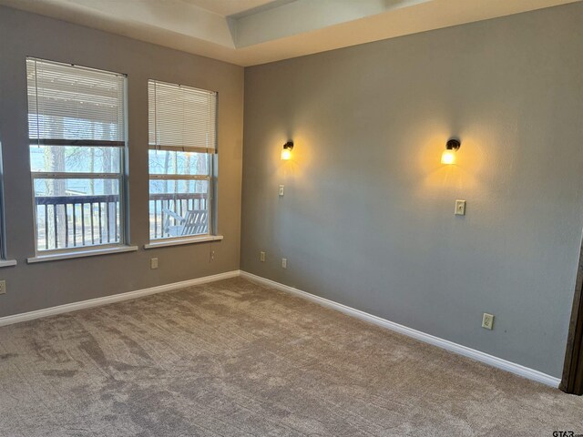 empty room with carpet and baseboards