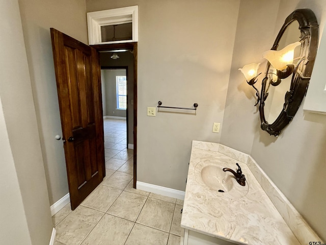 bathroom with tile patterned flooring, vanity, and baseboards