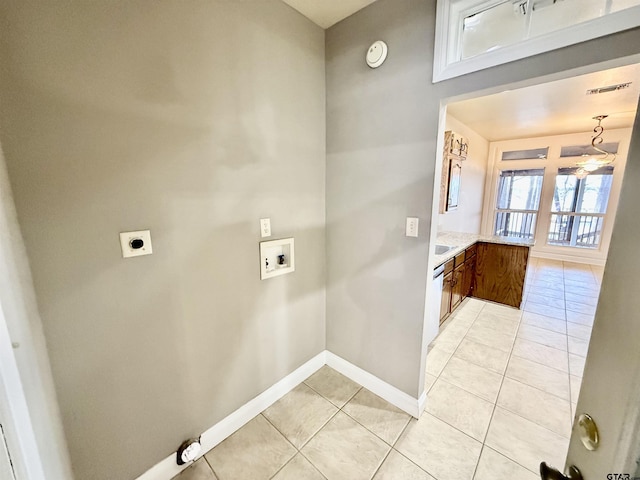 laundry area featuring baseboards, washer hookup, light tile patterned floors, laundry area, and electric dryer hookup