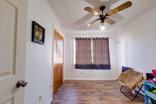 sitting room with dark hardwood / wood-style floors and ceiling fan