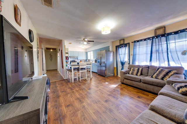 living room with hardwood / wood-style flooring and ceiling fan