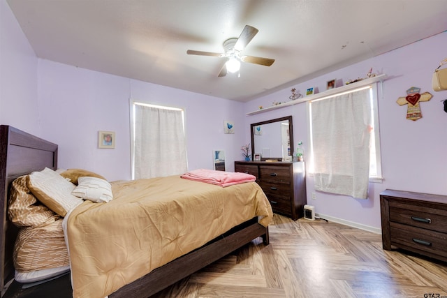 bedroom with ceiling fan and light parquet floors