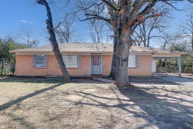 ranch-style house with a front lawn and a carport