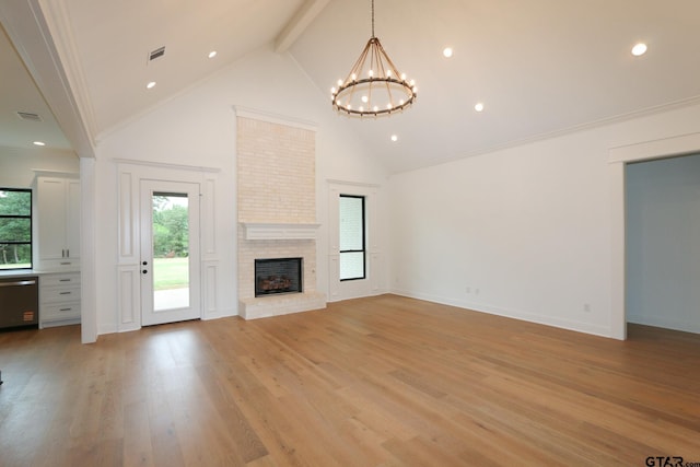 16511 Cooper Way, Tyler, TX 75703 - unfurnished living room featuring high vaulted ceiling, a chandelier, beam ceiling, a brick fireplace, and light wood-style floors
