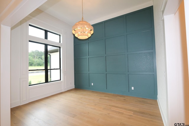 16511 Cooper Way, Tyler, TX 75703 - spare room with a decorative wall, a chandelier, and light wood-type flooring