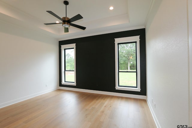 16511 Cooper Way, Tyler, TX 75703 - empty room with light wood finished floors, ceiling fan, baseboards, ornamental molding, and a tray ceiling