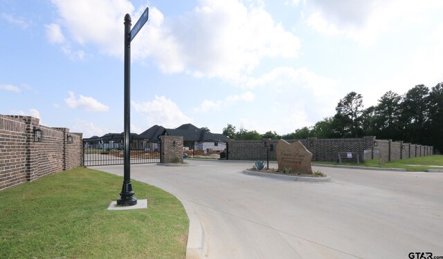 16511 Cooper Way, Tyler, TX 75703 - view of concrete road with a gate and curbs