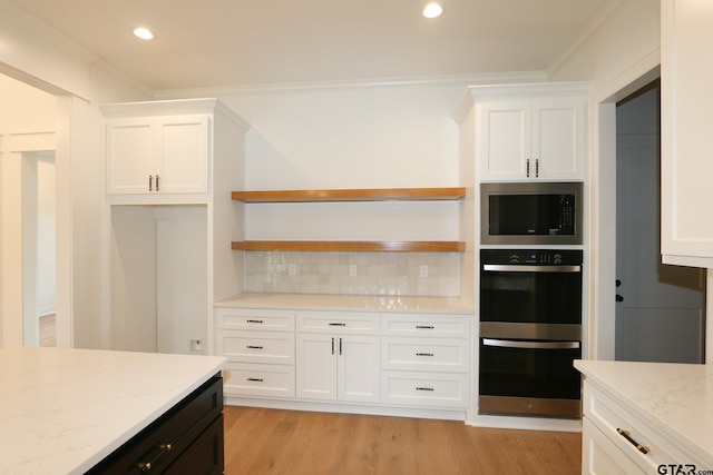 16511 Cooper Way, Tyler, TX 75703 - kitchen with stainless steel microwave, open shelves, double oven, white cabinetry, and ornamental molding