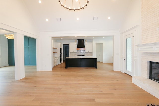 16511 Cooper Way, Tyler, TX 75703 - unfurnished living room featuring a fireplace, high vaulted ceiling, a chandelier, light wood finished floors, and recessed lighting