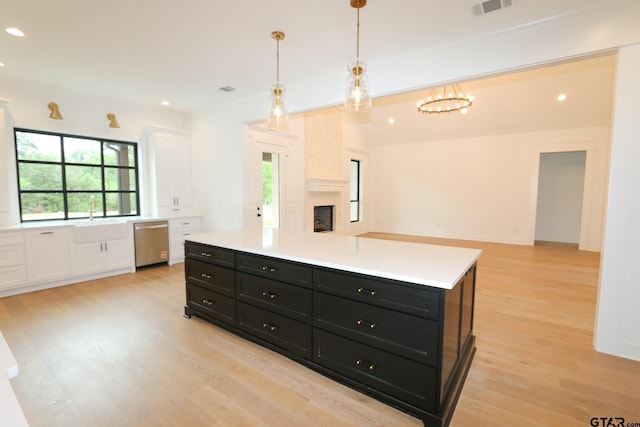 16511 Cooper Way, Tyler, TX 75703 - kitchen featuring dark cabinets, dishwasher, light wood-style flooring, white cabinetry, and light countertops