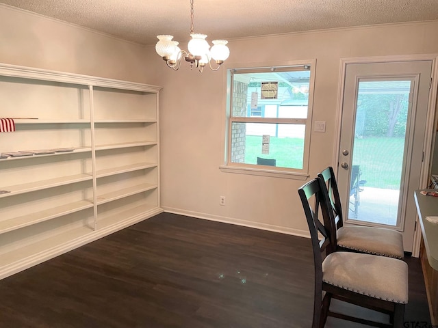 114 Briar Ln, Crockett, TX 75835 - unfurnished dining area featuring a textured ceiling, dark wood finished floors, a chandelier, crown molding, and baseboards