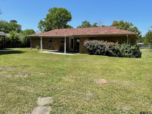 114 Briar Ln, Crockett, TX 75835 - rear view of house featuring a lawn and a patio