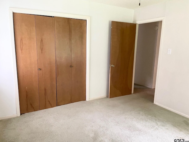 114 Briar Ln, Crockett, TX 75835 - unfurnished bedroom featuring carpet flooring, a closet, and baseboards