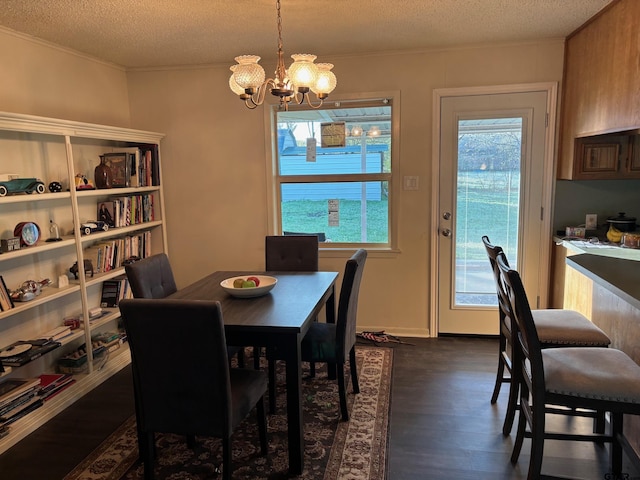 114 Briar Ln, Crockett, TX 75835 - dining area with dark wood-type flooring, a textured ceiling, crown molding, and a chandelier