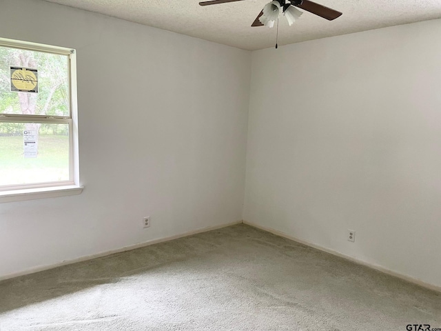 114 Briar Ln, Crockett, TX 75835 - carpeted spare room featuring ceiling fan, healthy amount of natural light, a textured ceiling, and baseboards