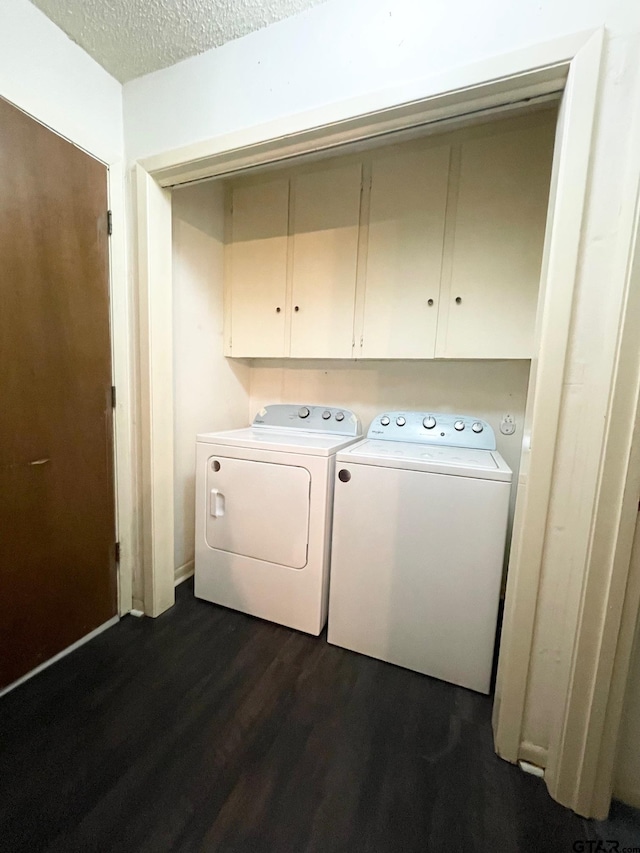 114 Briar Ln, Crockett, TX 75835 - laundry area with washer and clothes dryer, dark wood finished floors, cabinet space, and a textured ceiling