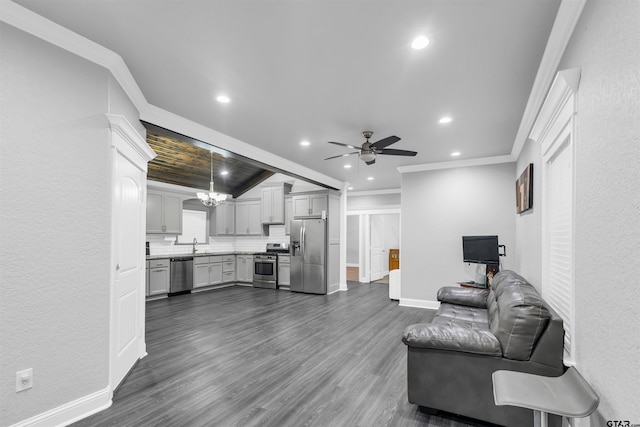 living room featuring dark hardwood / wood-style flooring, sink, ceiling fan with notable chandelier, and ornamental molding