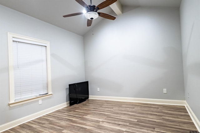 empty room with ceiling fan, lofted ceiling, and light wood-type flooring