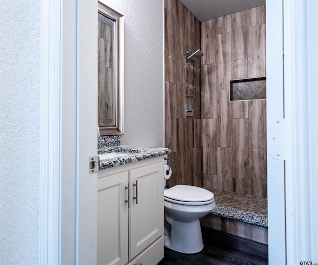 bathroom with a shower, vanity, and toilet