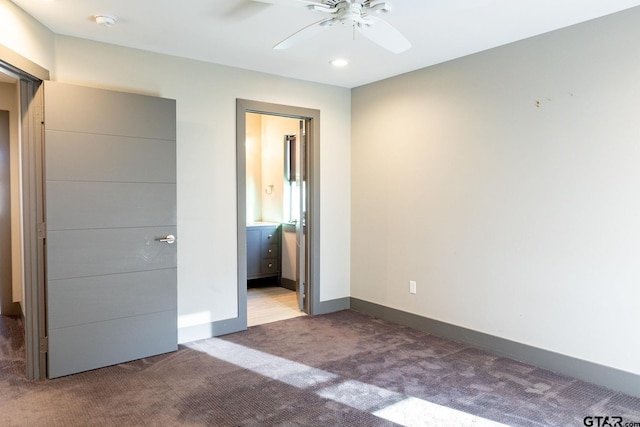 unfurnished bedroom featuring a ceiling fan, baseboards, carpet flooring, and ensuite bathroom